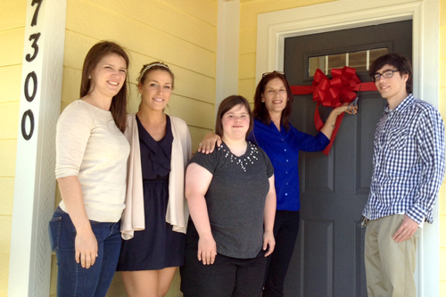 Marian Glenn and her children prepare to cut the ribbon on their new home
